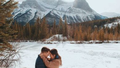 Man and woman in canada embracing each other near mountains