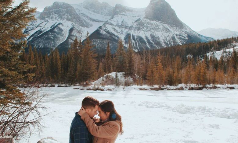 Man and woman in canada embracing each other near mountains