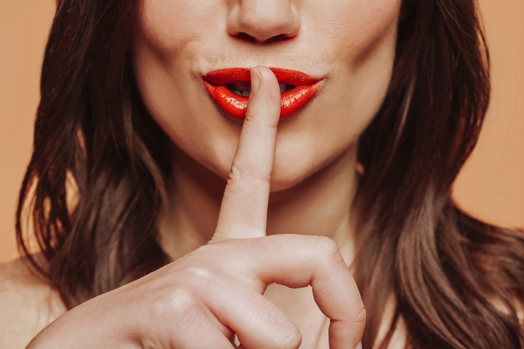 brunette woman with red lips doing silence gesture 2022 05 01 23 13 55 utc