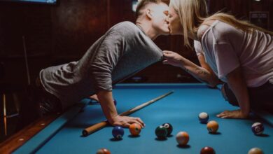 Two people kissing by a pool table 1024x682