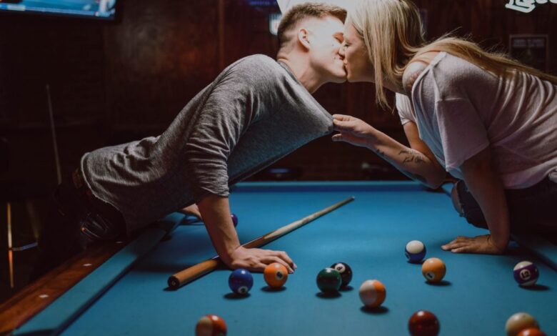 Two people kissing by a pool table 1024x682