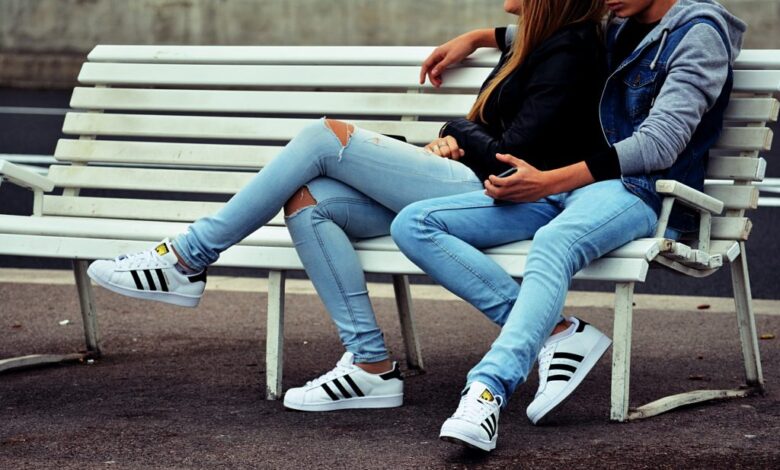 Guy and girl embracing on a park bench 1024x623