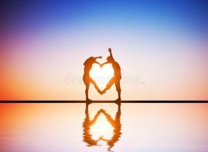 happy couple love making heart shape their bodies sunset water reflection 39162188 002 300x225