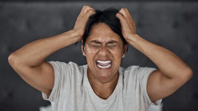 shouting headache and elderly woman in bed with insomnia vertigo or menopause in her home scream