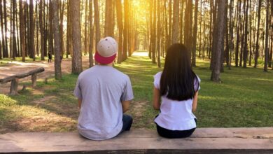 man and woman sitting on bench in woods stockpack pexels scaled e1722604819935