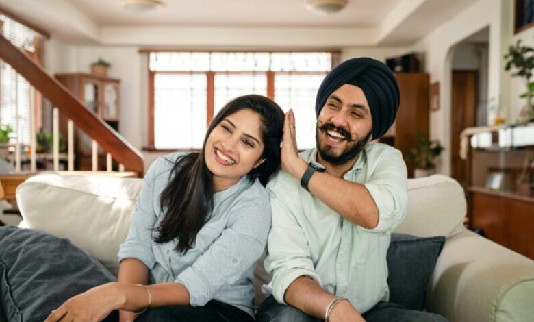 playful indian spouses having fun on sofa during weekend stockpack pexels scaled e1724754846550